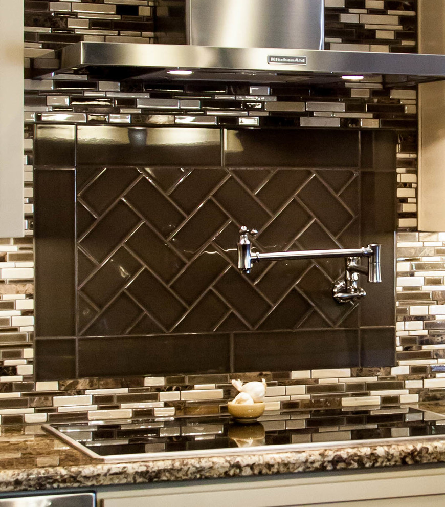 Large transitional l-shaped dark wood floor eat-in kitchen photo in Phoenix with an undermount sink, recessed-panel cabinets, white cabinets, granite countertops, multicolored backsplash, glass tile backsplash, stainless steel appliances and an island