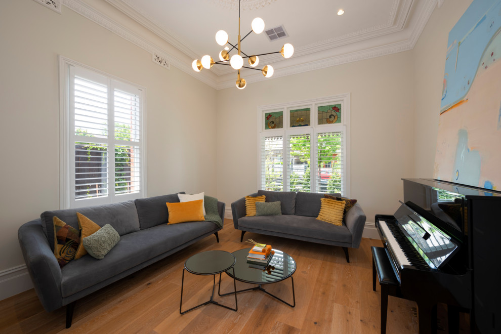 Photo of a mid-sized contemporary formal open concept living room in Melbourne with light hardwood floors.