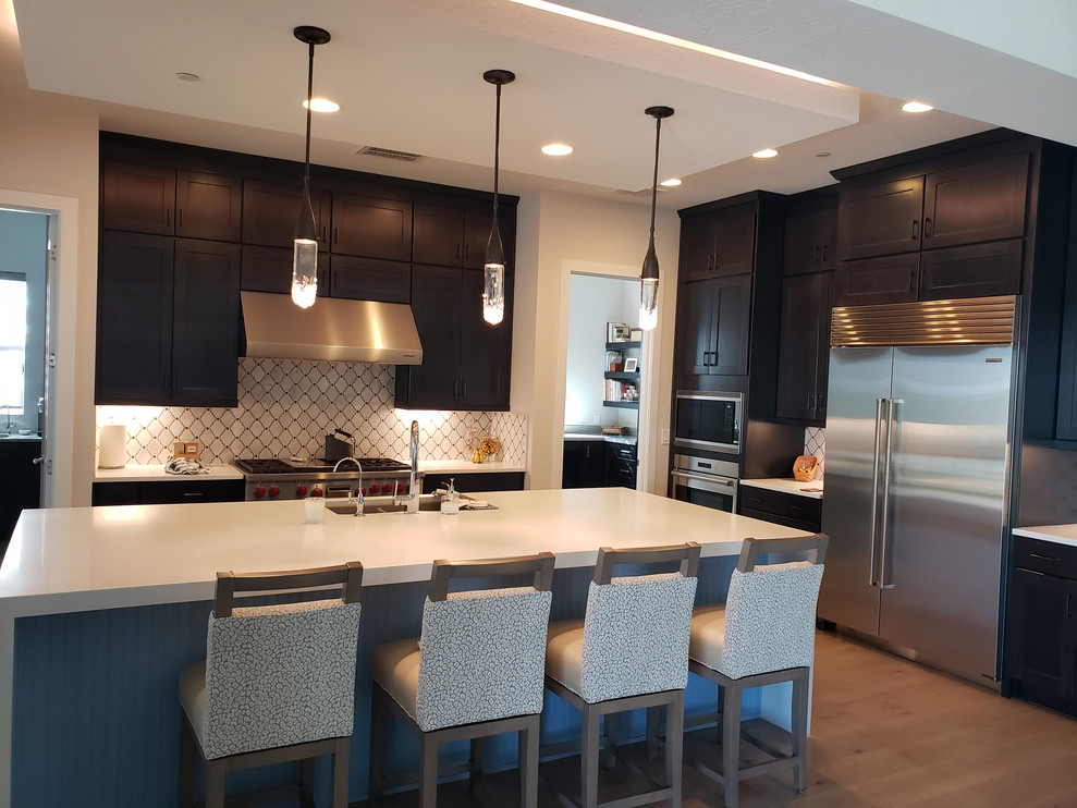 Huge transitional porcelain tile eat-in kitchen photo in Phoenix with an undermount sink, shaker cabinets, dark wood cabinets, quartz countertops, multicolored backsplash, mosaic tile backsplash, stainless steel appliances, an island and white countertops