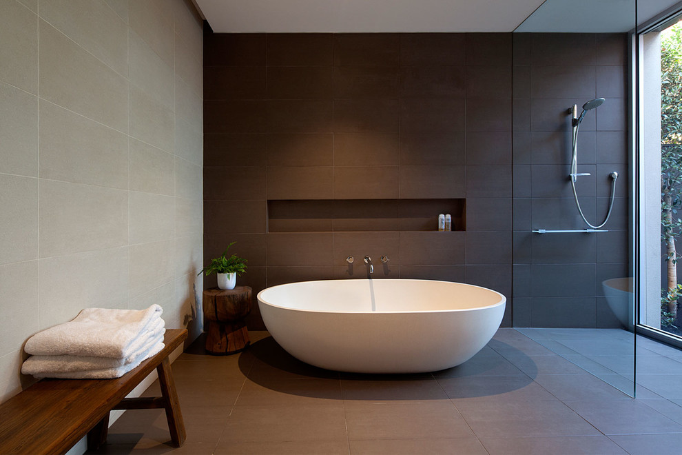 Contemporary bathroom in Melbourne with a freestanding tub and brown tile.
