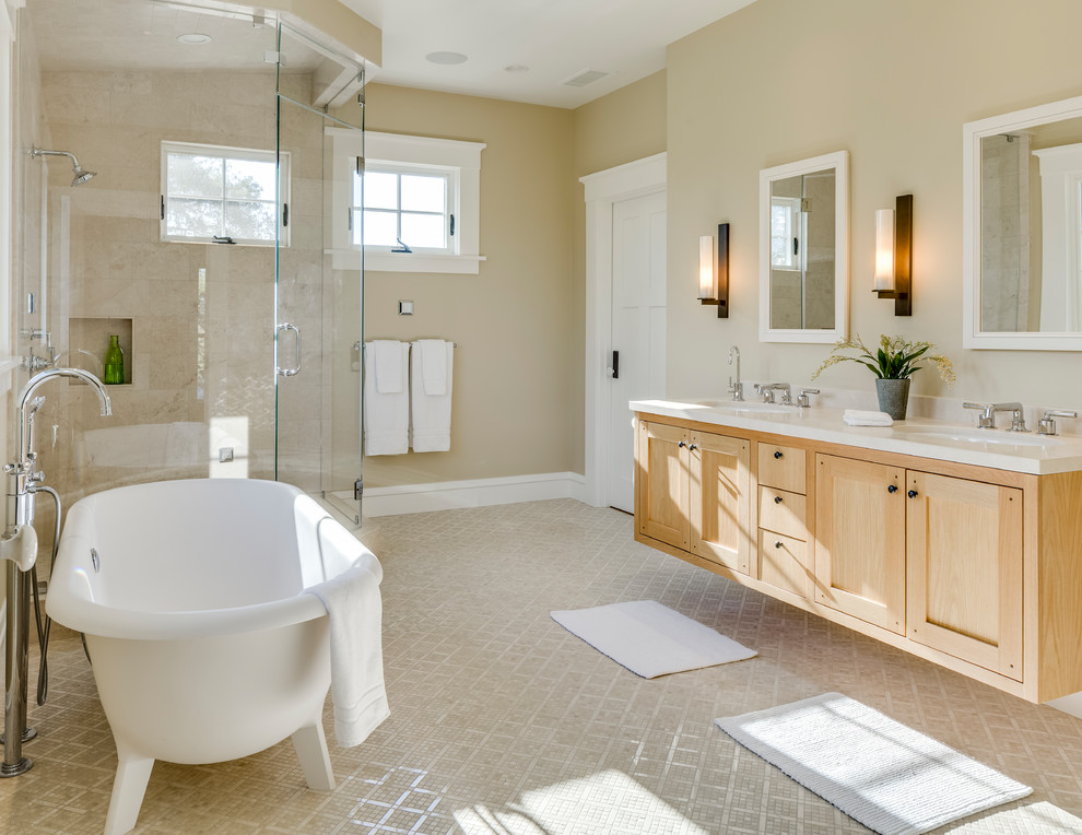 Photo of a mid-sized arts and crafts master bathroom in San Francisco with recessed-panel cabinets, light wood cabinets, a freestanding tub, a corner shower, a two-piece toilet, beige tile, porcelain tile, beige walls, mosaic tile floors, an undermount sink, engineered quartz benchtops, beige floor, a hinged shower door and white benchtops.