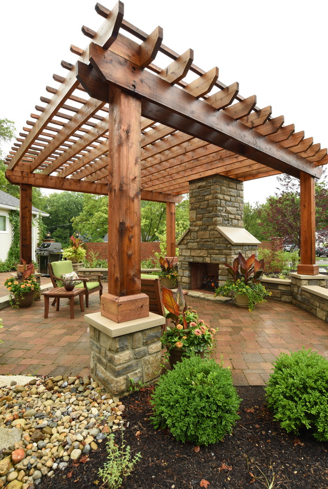 Photo of a large transitional backyard patio in Columbus with brick pavers and a pergola.