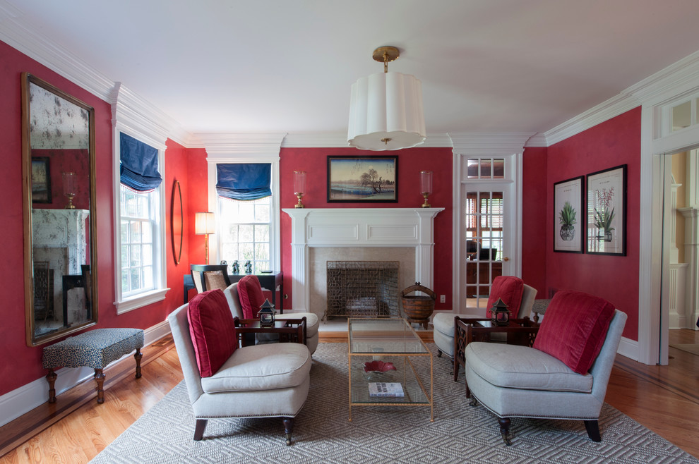 Design ideas for a large eclectic formal enclosed living room in Other with red walls, medium hardwood floors, a standard fireplace and a stone fireplace surround.