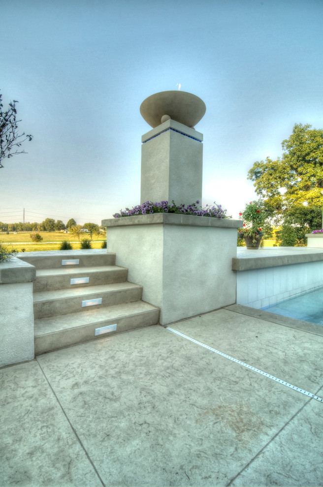 Example of a large transitional backyard concrete paver and rectangular natural hot tub design in Cedar Rapids