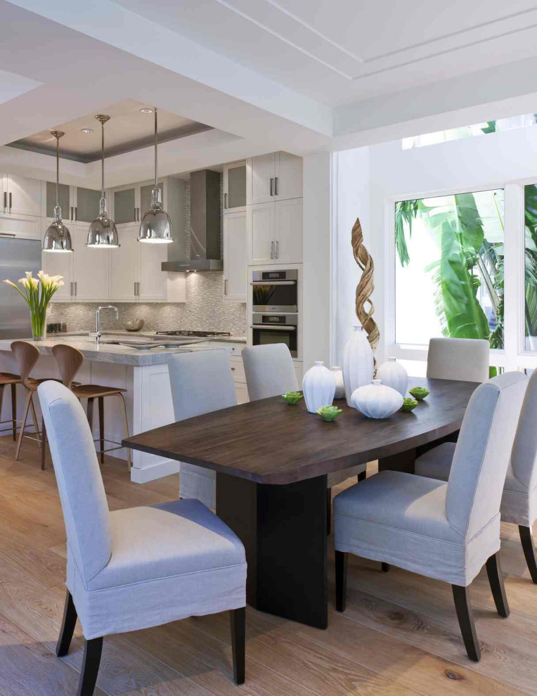 Inspiration for a large transitional kitchen/dining combo in Miami with white walls, light hardwood floors and beige floor.