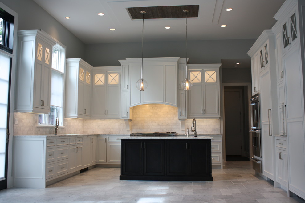 Large transitional u-shaped open plan kitchen in Chicago with a double-bowl sink, beaded inset cabinets, white cabinets, quartzite benchtops, white splashback, subway tile splashback, stainless steel appliances, marble floors and with island.