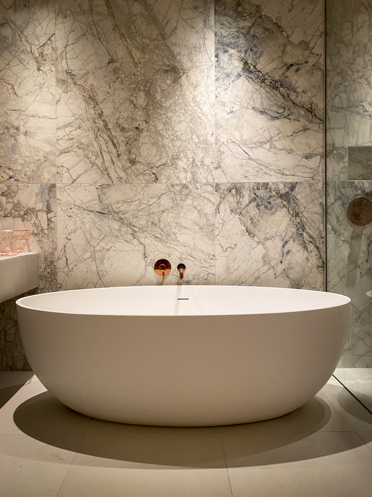 Inspiration for a medium sized contemporary family bathroom in Other with a freestanding bath, a walk-in shower, a wall mounted toilet, white tiles, porcelain tiles, white walls, porcelain flooring, a vessel sink, tiled worktops, white floors, an open shower, beige worktops, a single sink and a built in vanity unit.