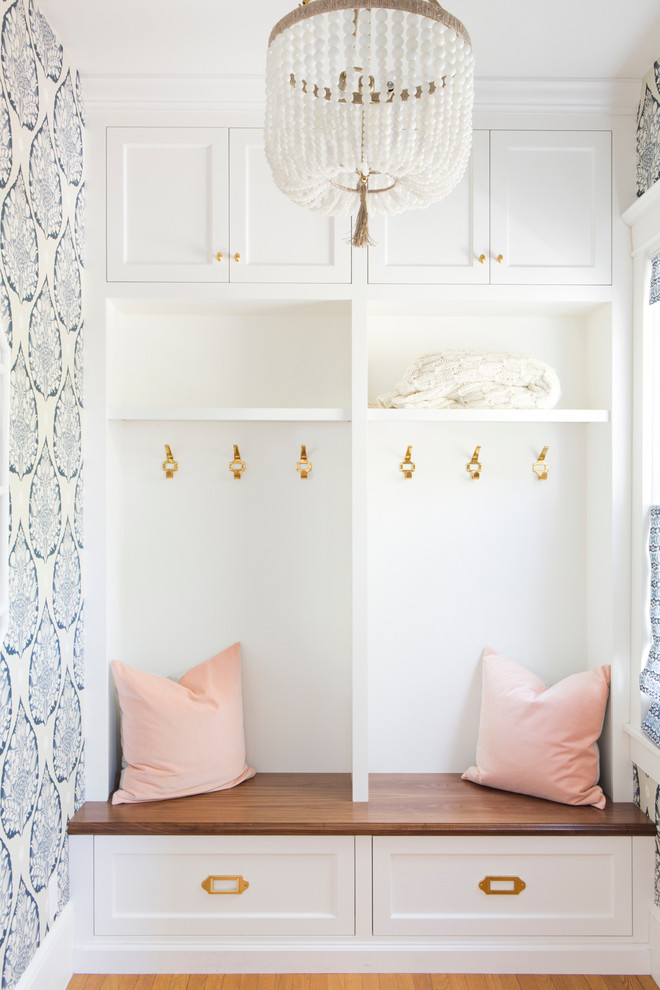 Photo of a small transitional mudroom in San Francisco with light hardwood floors, a single front door and blue walls.