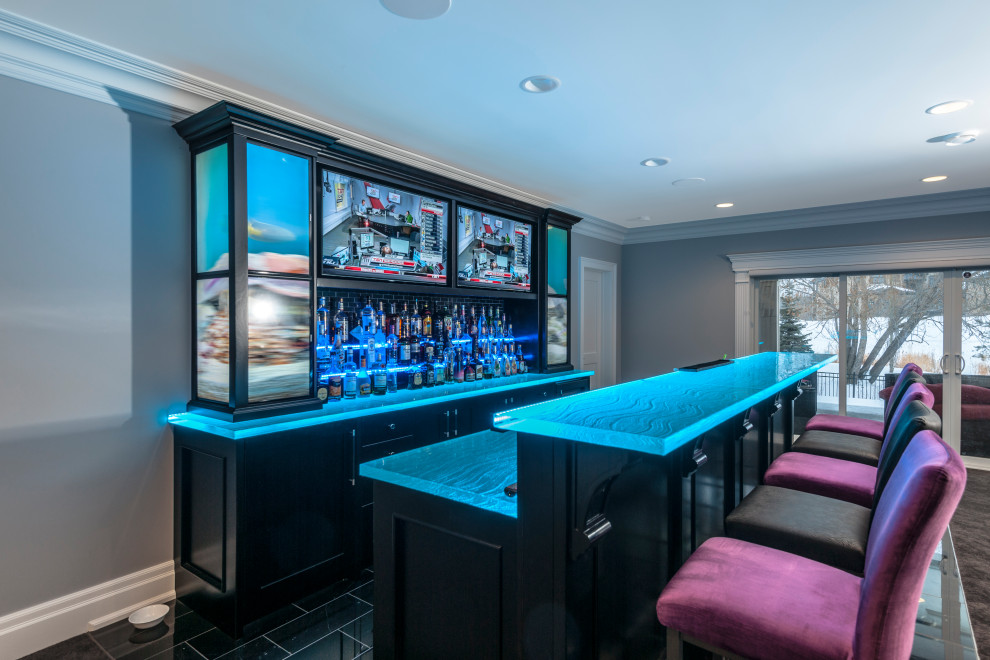 Photo of a modern galley wet bar in Edmonton with an undermount sink, flat-panel cabinets, black cabinets, glass benchtops and blue benchtop.
