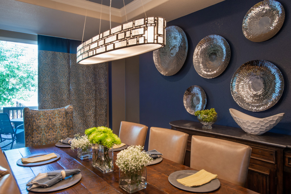This is an example of a contemporary separate dining room in Denver with blue walls, medium hardwood floors, a two-sided fireplace and a stone fireplace surround.