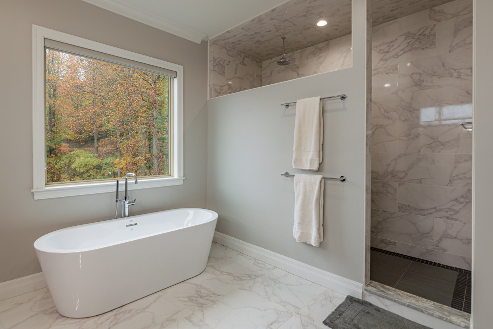 This is an example of a large transitional master bathroom in Atlanta with flat-panel cabinets, black cabinets, a freestanding tub, an alcove shower, a two-piece toilet, gray tile, ceramic tile, beige walls, ceramic floors, an undermount sink, granite benchtops, grey floor, an open shower and multi-coloured benchtops.