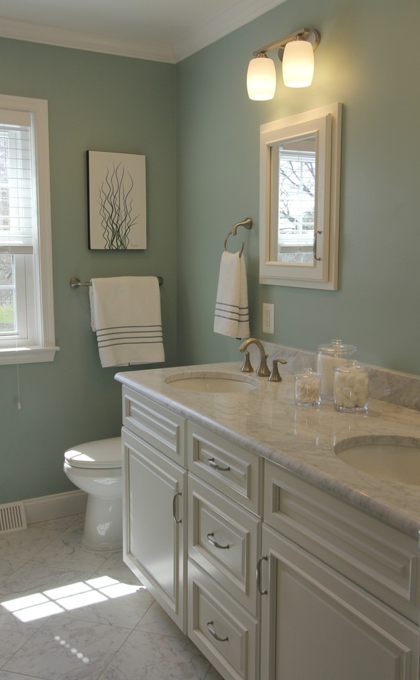 Design ideas for a mid-sized transitional master bathroom in Baltimore with recessed-panel cabinets, white cabinets, an alcove tub, a shower/bathtub combo, a two-piece toilet, white tile, gray tile, multi-coloured tile, stone tile, green walls, marble floors, an undermount sink, marble benchtops, grey floor, white benchtops, a niche, a double vanity and a built-in vanity.
