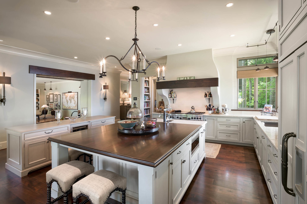 Design ideas for a mid-sized transitional l-shaped open plan kitchen in Charlotte with an undermount sink, quartz benchtops, panelled appliances, dark hardwood floors, multiple islands and brown floor.