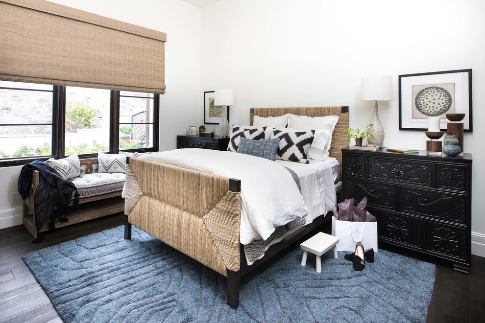 Mediterranean bedroom in Orange County with white walls, dark hardwood floors and brown floor.