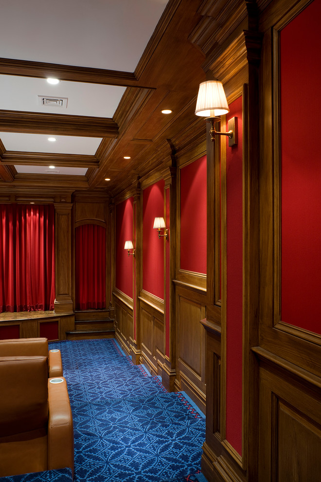 Large transitional enclosed home theatre in New York with red walls, carpet, a projector screen and blue floor.