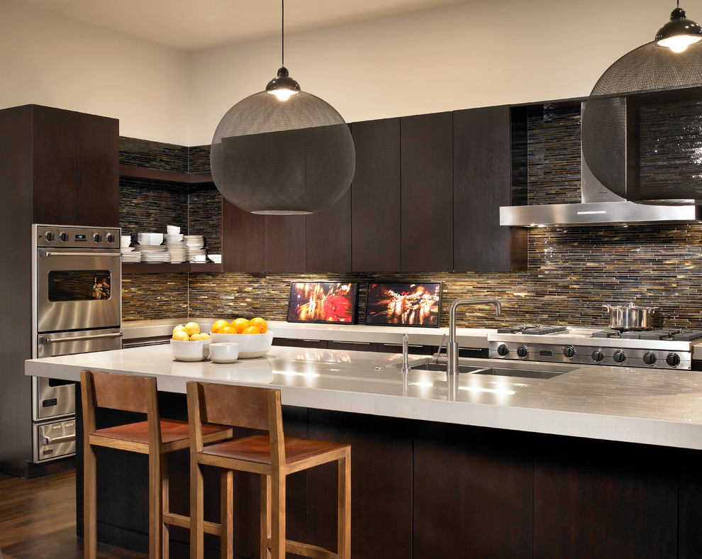 Contemporary kitchen in Chicago with a double-bowl sink, flat-panel cabinets, dark wood cabinets, brown splashback, matchstick tile splashback and stainless steel appliances.