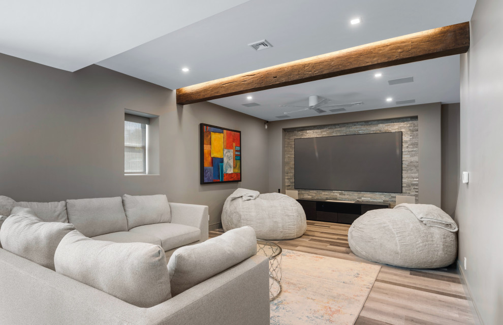 Inspiration for a large country home theatre in Philadelphia with grey walls, laminate floors, a projector screen and grey floor.