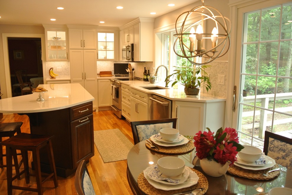 Eat-in kitchen - transitional medium tone wood floor eat-in kitchen idea in Boston with an undermount sink, shaker cabinets, quartz countertops, beige backsplash, mosaic tile backsplash, stainless steel appliances, an island and white countertops