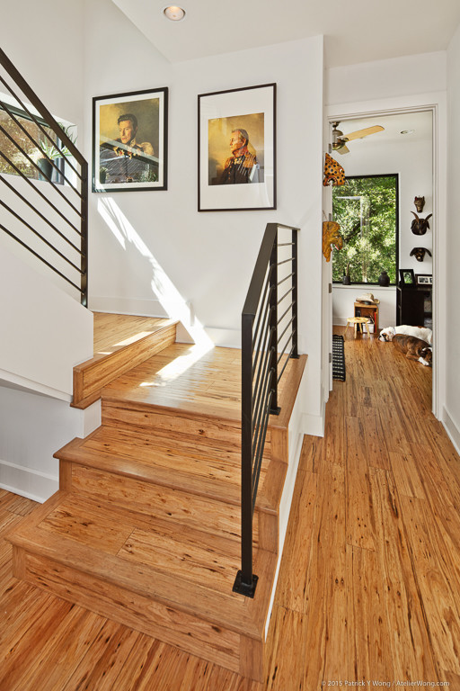 Mid-sized modern wood u-shaped staircase in Austin with wood risers.