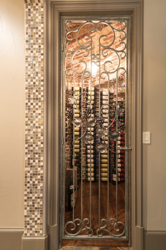 Photo of a small traditional wine cellar in Dallas with dark hardwood floors and storage racks.