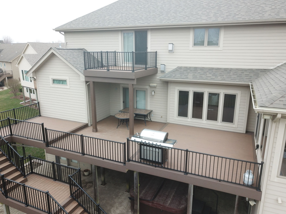 Inspiration for a large backyard second story metal railing deck remodel with no cover
