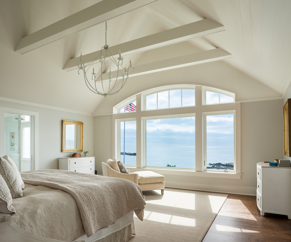 Design ideas for a beach style bedroom in Bridgeport with beige walls and dark hardwood floors.