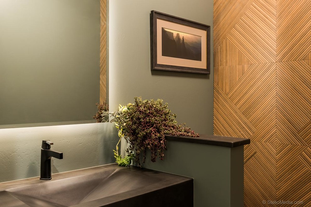 Small contemporary powder room in Albuquerque with brown tile, porcelain tile, green walls, concrete benchtops and black benchtops.