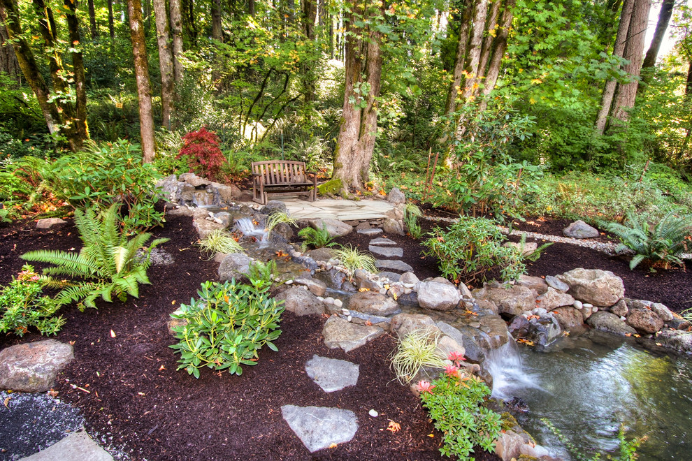 This is an example of a country garden in Portland with a water feature.