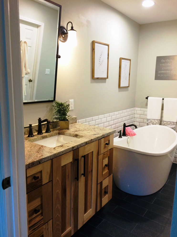 Bathroom - rustic white tile and subway tile ceramic tile, blue floor and single-sink bathroom idea with shaker cabinets, medium tone wood cabinets, granite countertops and beige countertops