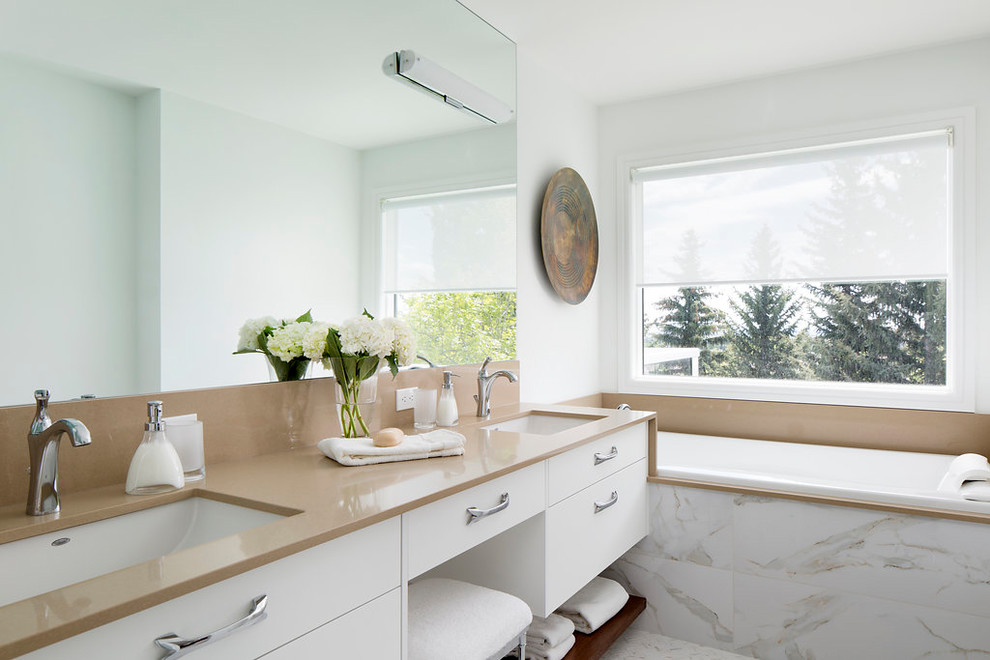 Design ideas for a large contemporary master bathroom in Calgary with flat-panel cabinets, white cabinets, a drop-in tub, white walls, an undermount sink, marble floors, engineered quartz benchtops, multi-coloured floor and brown benchtops.