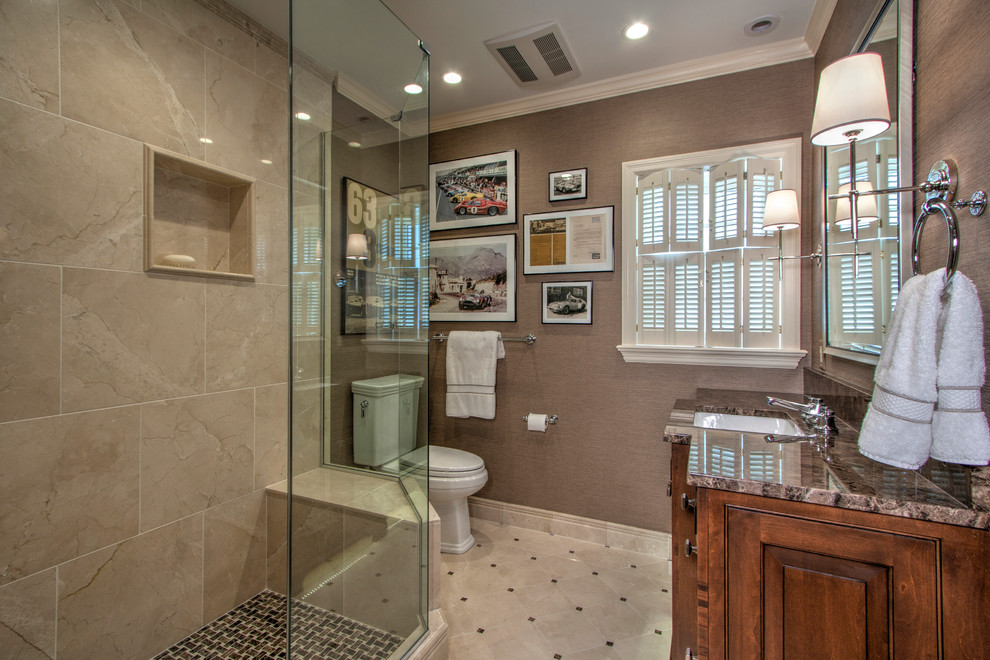 Design ideas for a mid-sized transitional master bathroom in St Louis with furniture-like cabinets, medium wood cabinets, an open shower, a two-piece toilet, beige tile, stone tile, brown walls, marble floors, an undermount sink and granite benchtops.