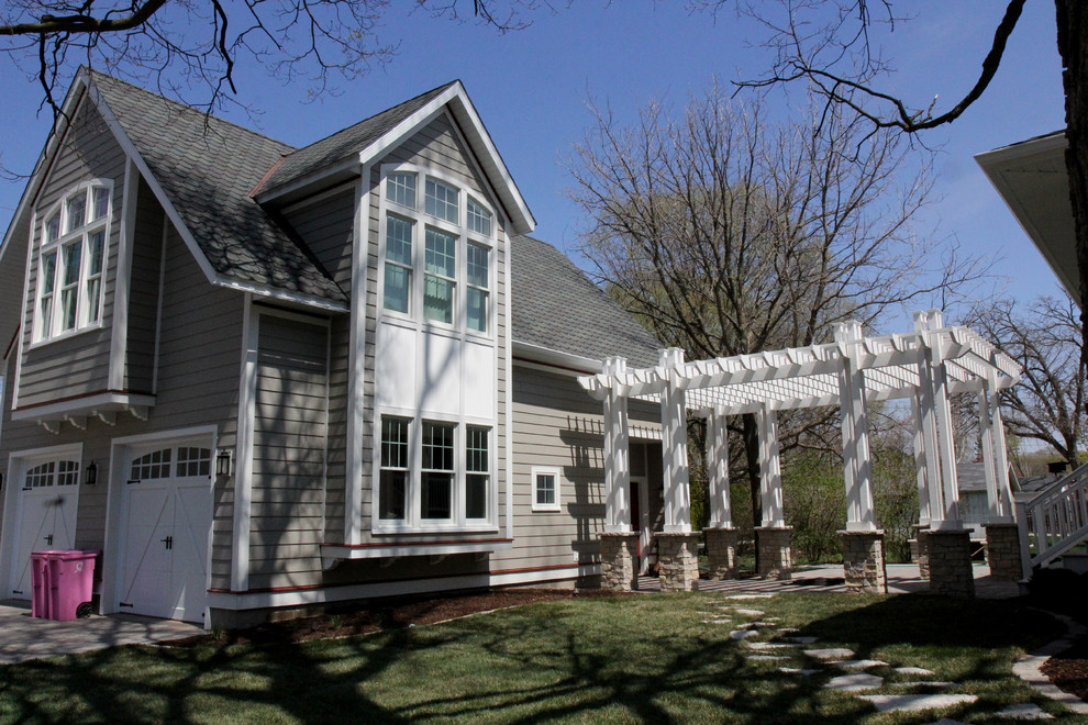 Traditional two-storey exterior in Chicago with wood siding and a gable roof.