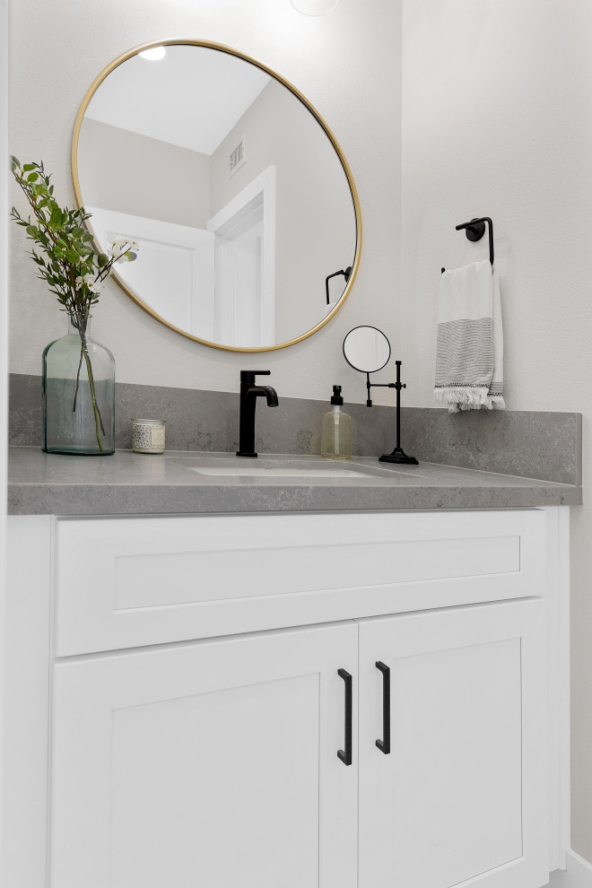 Inspiration for a mid-sized modern 3/4 bathroom in Orange County with recessed-panel cabinets, white cabinets, an alcove tub, a shower/bathtub combo, a one-piece toilet, beige tile, beige walls, mosaic tile floors, an undermount sink, grey floor, a shower curtain, grey benchtops, an enclosed toilet, a single vanity and a built-in vanity.