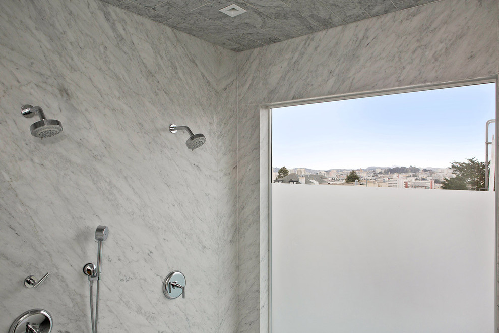 Photo of a large contemporary master bathroom in San Francisco with furniture-like cabinets, medium wood cabinets, an alcove tub, an open shower, a wall-mount toilet, white tile, stone slab, beige walls, marble floors, an undermount sink and concrete benchtops.