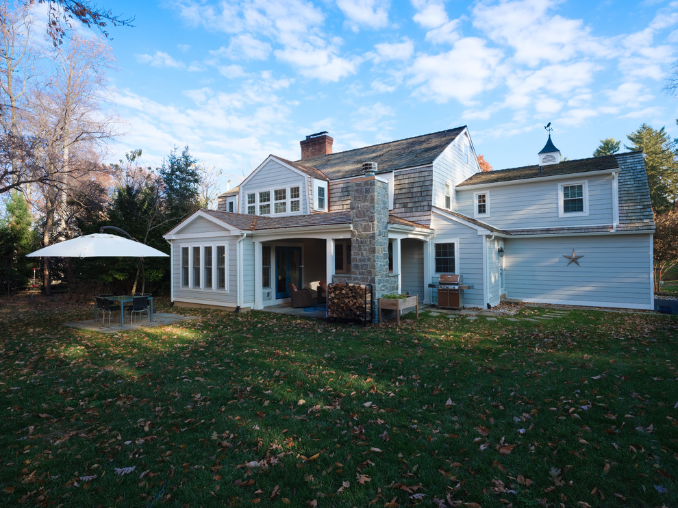 Design ideas for a transitional backyard patio in Other with a fire feature, a roof extension and natural stone pavers.