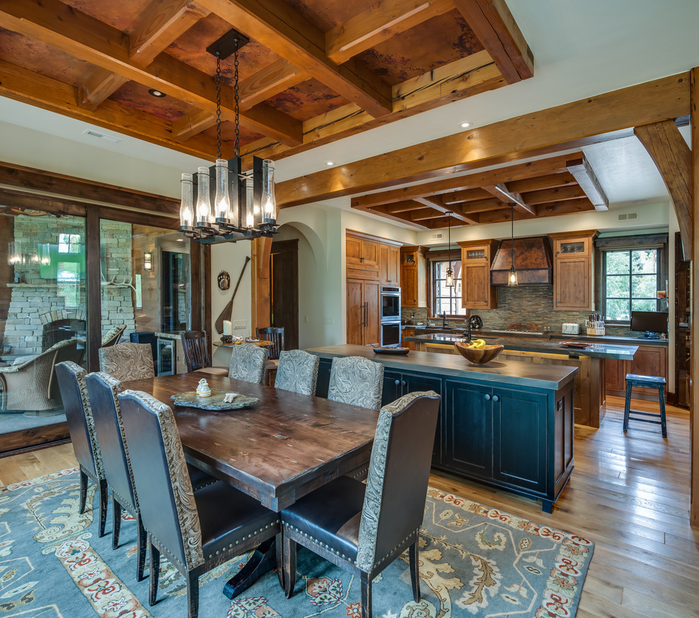 Mid-sized country separate dining room in Other with beige walls, light hardwood floors, no fireplace and brown floor.