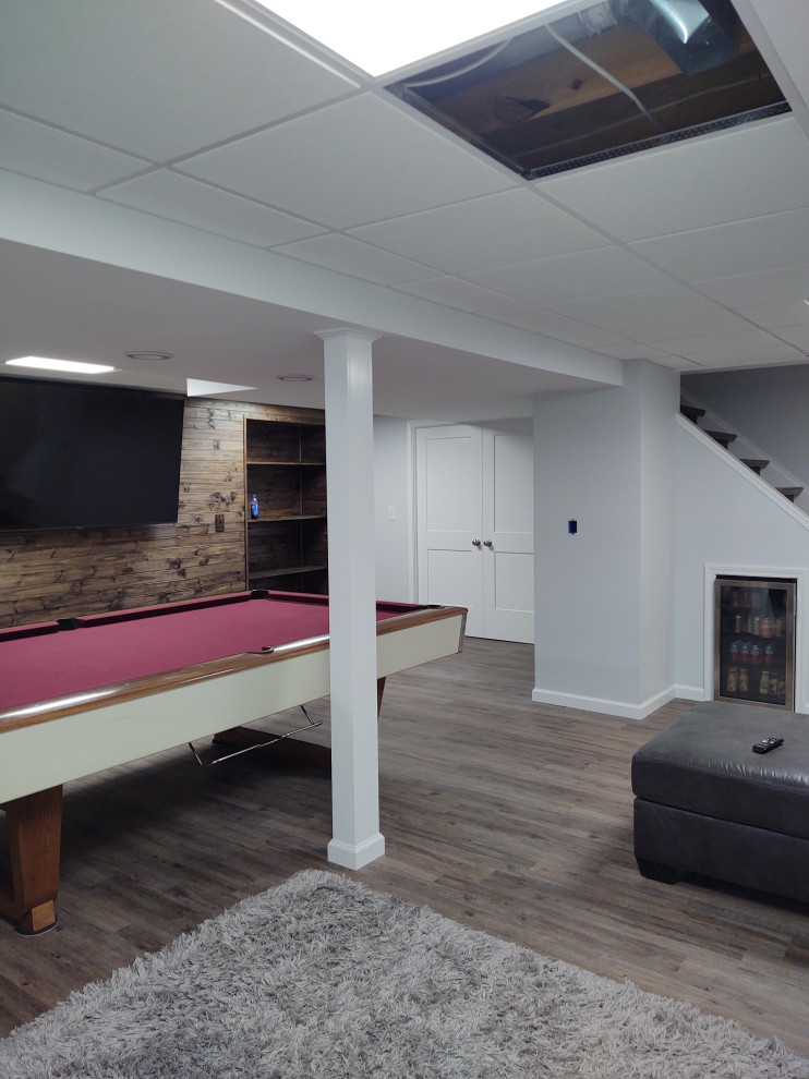 Inspiration pour un sous-sol minimaliste semi-enterré avec salle de jeu, un sol en bois brun, un sol marron et différents designs de plafond.
