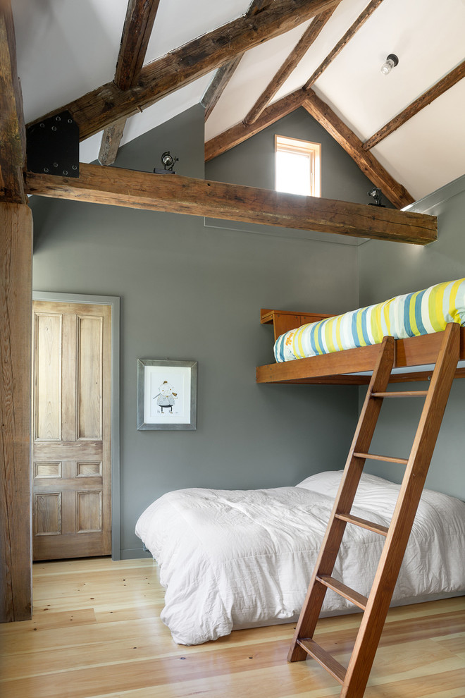 This is an example of a country gender-neutral kids' bedroom for kids 4-10 years old in Portland Maine with grey walls and light hardwood floors.