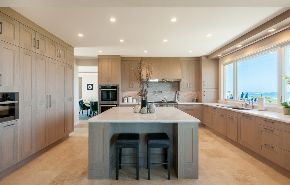 This is an example of a large transitional u-shaped kitchen pantry in San Francisco with a single-bowl sink, shaker cabinets, light wood cabinets, granite benchtops, grey splashback, cement tile splashback, stainless steel appliances, ceramic floors, with island and beige floor.
