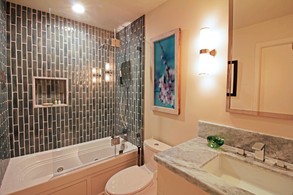 Inspiration for a small contemporary 3/4 bathroom in San Francisco with flat-panel cabinets, white cabinets, an alcove tub, a shower/bathtub combo, a two-piece toilet, black tile, ceramic tile, beige walls, bamboo floors, an undermount sink, granite benchtops, a hinged shower door and grey benchtops.