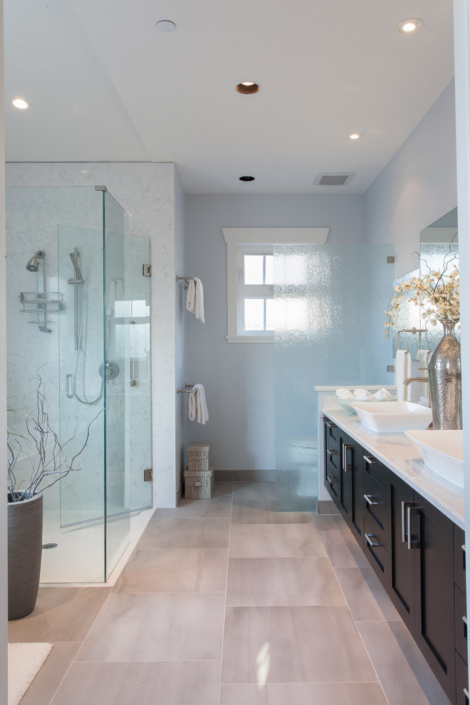 This is an example of a transitional master bathroom in Vancouver with a vessel sink, shaker cabinets, engineered quartz benchtops, a curbless shower, gray tile, ceramic tile, blue walls, ceramic floors and dark wood cabinets.