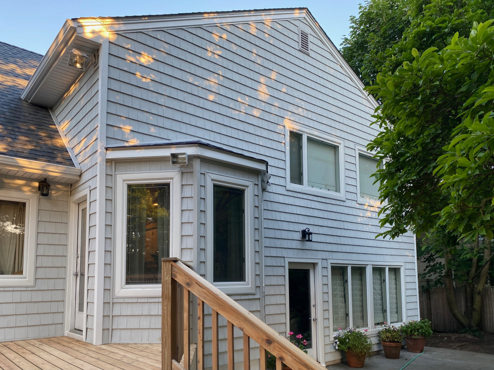 This is an example of a traditional grey exterior in New York with vinyl siding.