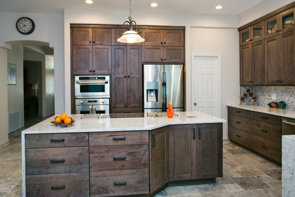 Inspiration for a porcelain tile kitchen remodel in Phoenix with an undermount sink, shaker cabinets, gray cabinets, quartz countertops, white backsplash, ceramic backsplash, stainless steel appliances and an island