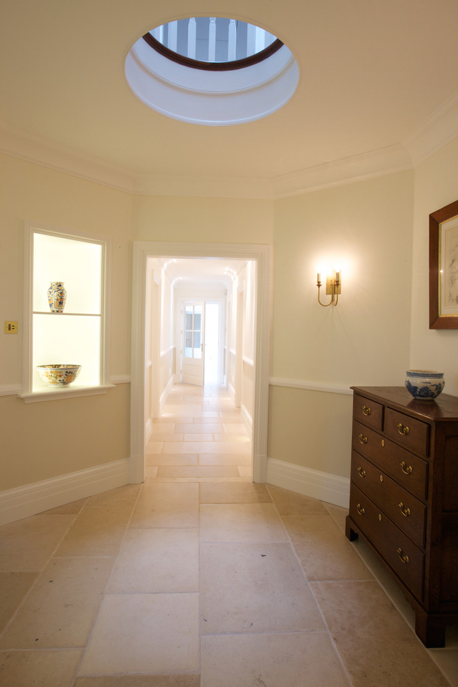 This is an example of a modern hallway in Wiltshire with limestone floors.