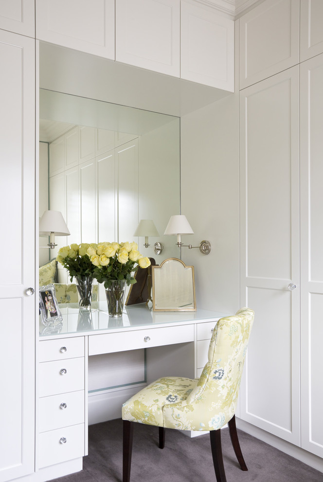 Inspiration for a mid-sized traditional women's storage and wardrobe in Sydney with recessed-panel cabinets, white cabinets and carpet.