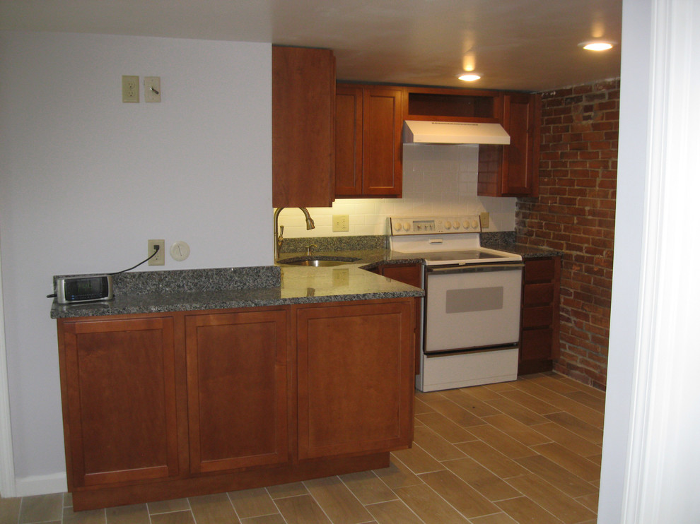 Inspiration for a small transitional l-shaped porcelain tile eat-in kitchen remodel in Boston with shaker cabinets, medium tone wood cabinets, granite countertops, white backsplash, subway tile backsplash, white appliances and a single-bowl sink
