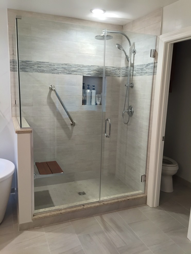 Mid-sized transitional master gray tile and porcelain tile porcelain tile freestanding bathtub photo in DC Metro with an undermount sink, shaker cabinets, medium tone wood cabinets, quartz countertops and gray walls