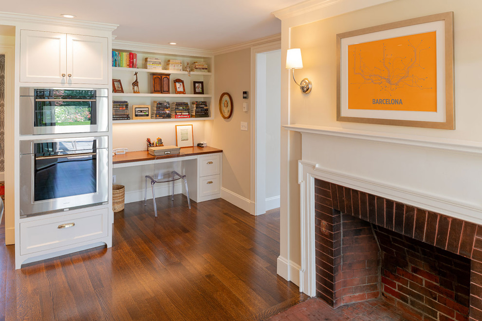 This is an example of a large midcentury u-shaped eat-in kitchen in Boston with an undermount sink, shaker cabinets, white cabinets, quartzite benchtops, white splashback, subway tile splashback, stainless steel appliances, dark hardwood floors, with island, brown floor and grey benchtop.