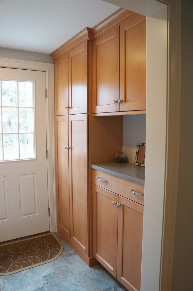 Inspiration for a transitional galley ceramic tile laundry room remodel in Boston with shaker cabinets, medium tone wood cabinets, quartz countertops and a side-by-side washer/dryer