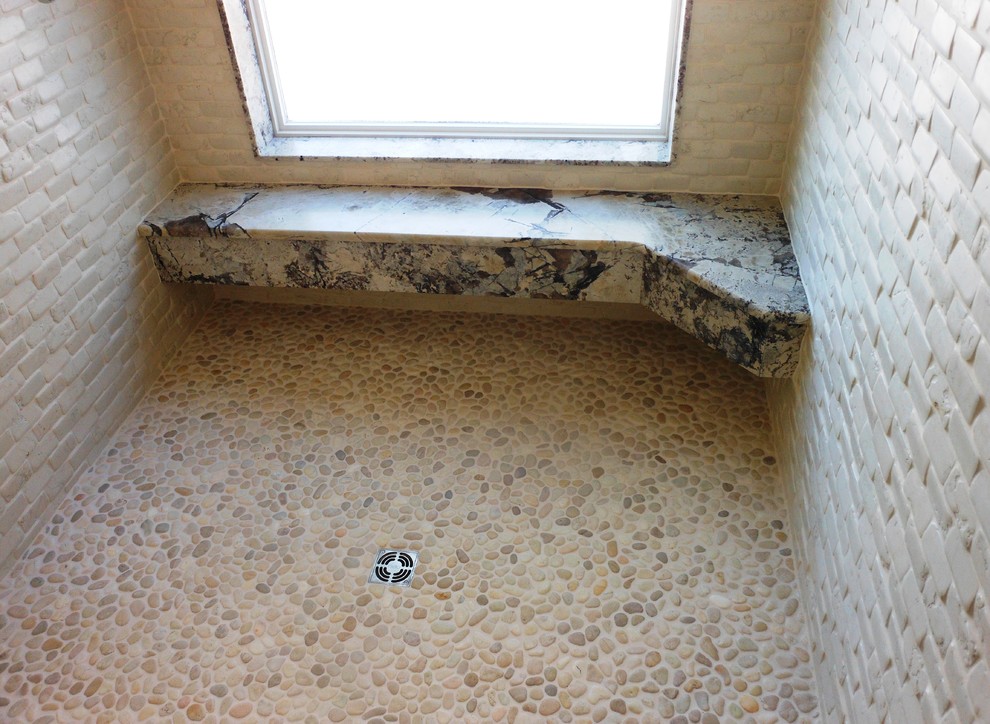 Walk-in shower - large rustic master beige tile and stone tile pebble tile floor walk-in shower idea with granite countertops
